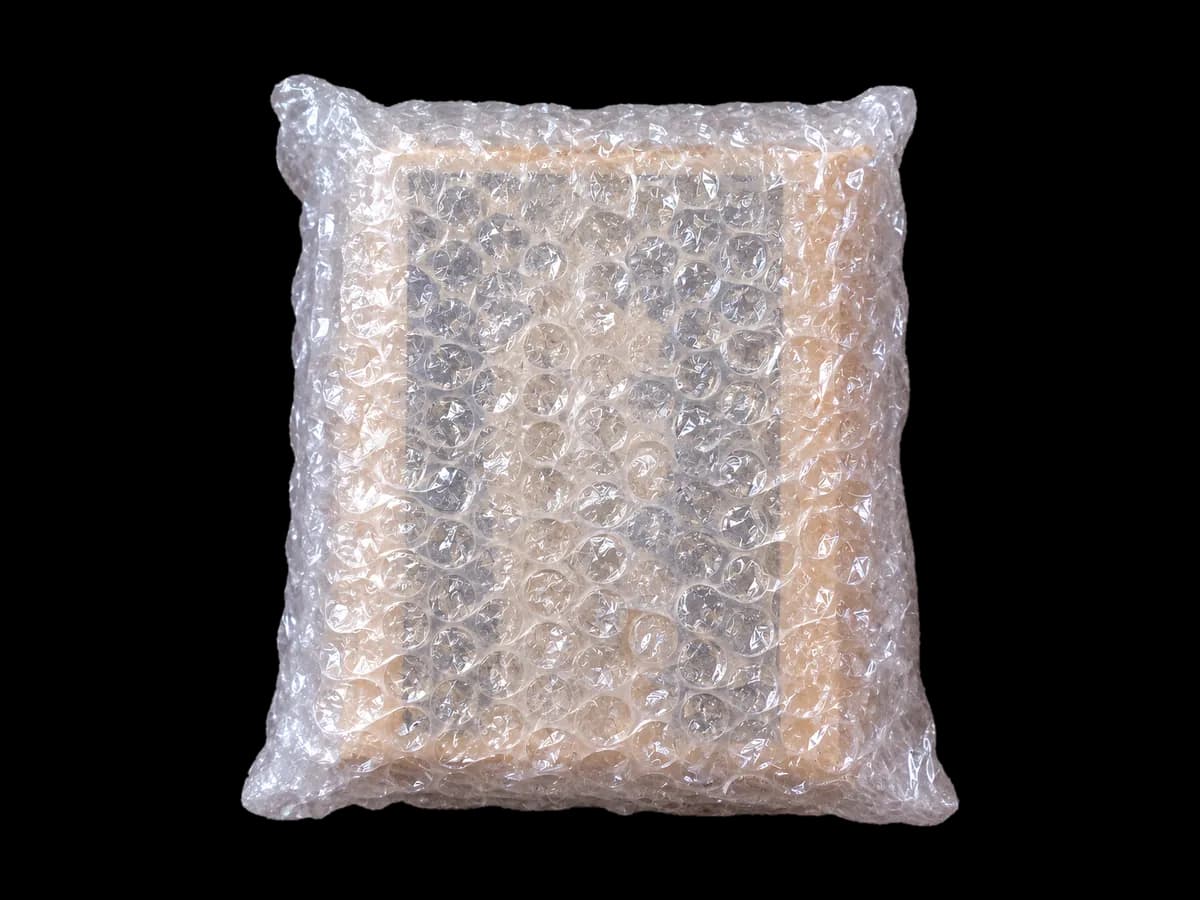 বাবল র‍্যাপে জড়ানো বই · A book wrapped in bubble wrap