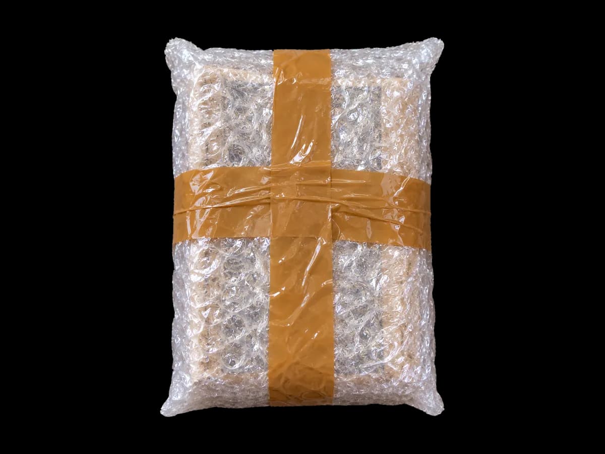 মজবুত টেপ দিয়ে প্যাকেট বন্ধ করা হচ্ছে · Sealing the parcel with strong tape